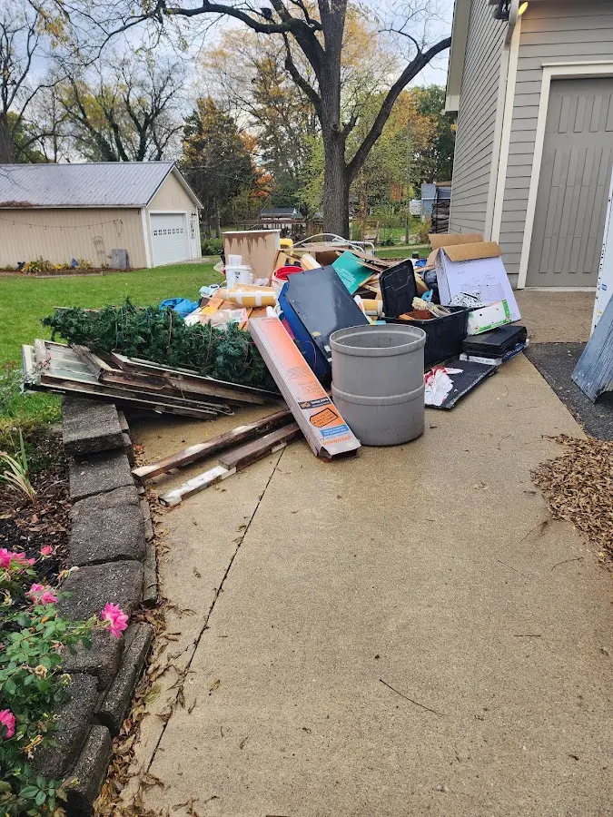 Dumpster being loaded with debris for 12 Yard Dumpster Rental in Kingstowne